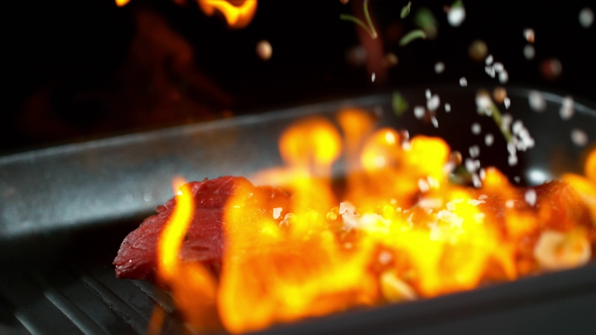 Super slow motion of falling beef steak into flames. Filmed on high speed cinema camera, 1000 fps. | Shutterstock HD Video #1038818819