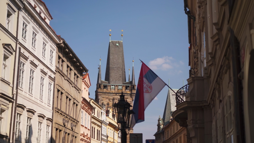View from the Karlova street of the Old Town Bridge Tower called Staromestska Kostecki Vez, Prague. National flag flattering on the wall.