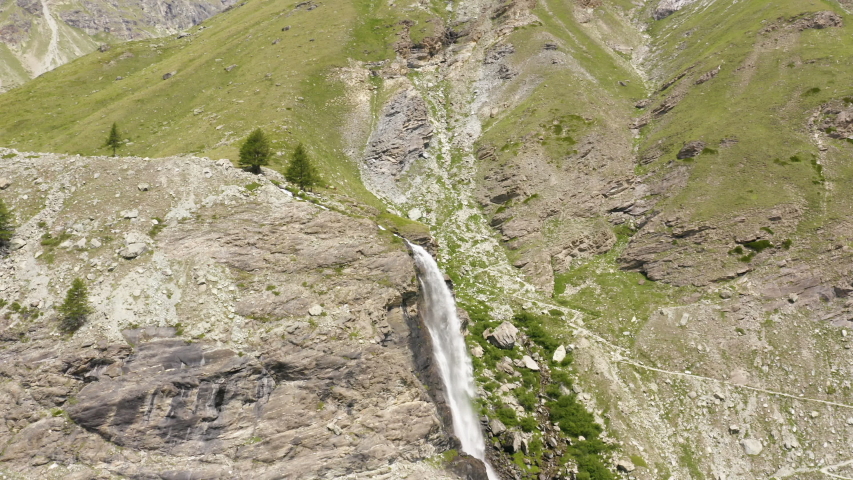 Aerial orbit around waterfall in Zermatt, Switzerland