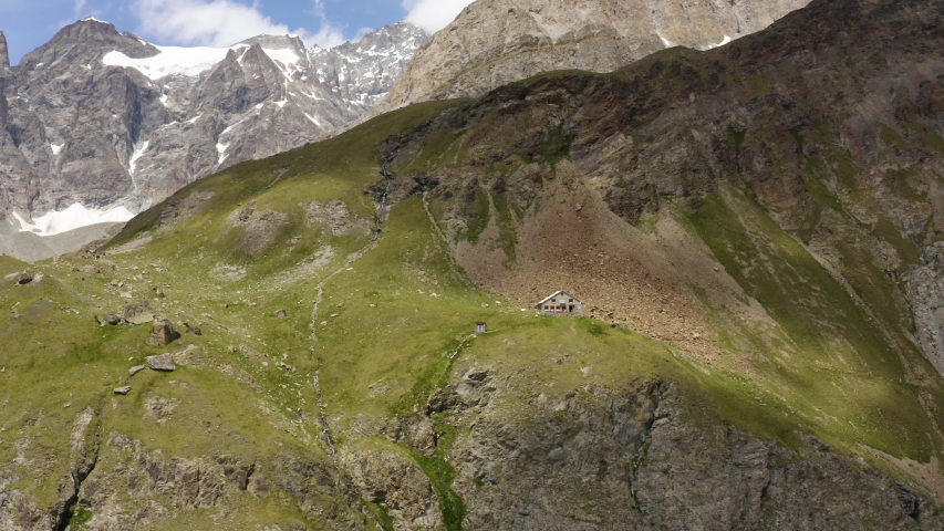 Aerial orbit descending around Schonebielhutte mountain hut in Zermatt, Switzerland