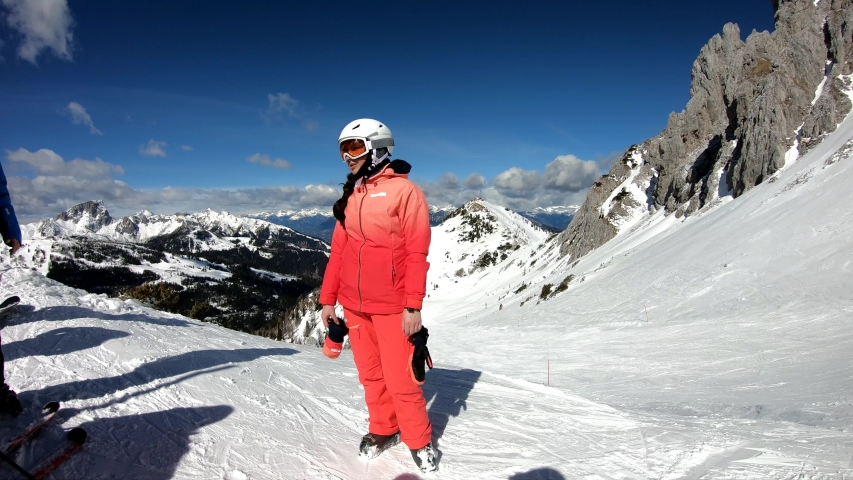 Pretty woman skiing. Young girl enjoying skiing. 
Young girl spending an active vacation in the Austrian Alps. Stabilized footage. Slow motion.
