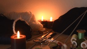 Cozy background of a knitting table with candles and knitting equipment - Powered by Shutterstock - Get 15% off with code: PIKWIZARD15