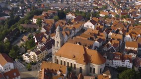 Aerial view of the City Hechingen in Germany on a sunny day in summer. Pan to the right beside the church.