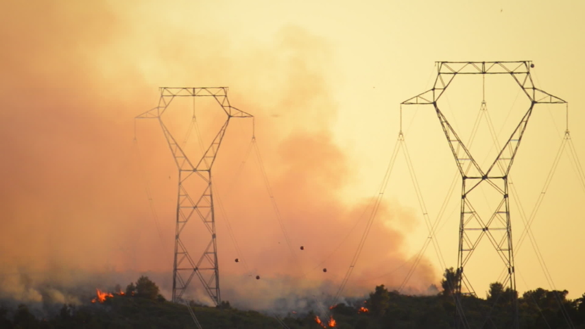 Summer heat waves and drought cause forest fires in Spain. Helicopters and birds fly over power lines.  Royalty-Free Stock Footage #1038847175