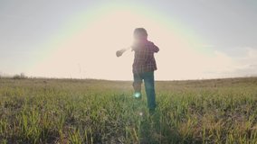 happy family little boy a runs concept slow motion video. happy child girl with sunset nature outdoors running on meadow in summer in nature. lifestyle happy carefree childhood concept