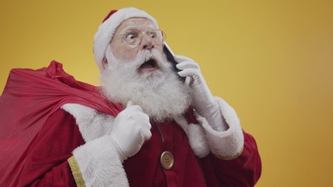 Holly jolly x mas! Santa in headwear, costume, black belt, white gloves brings gifts for kids, prepared to celebrate, sale promotion, winter december, chatting on telephone. Santa talking on the phone