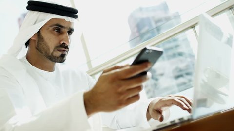 Arab businessman global hotel travel investment smart phone laptop technology