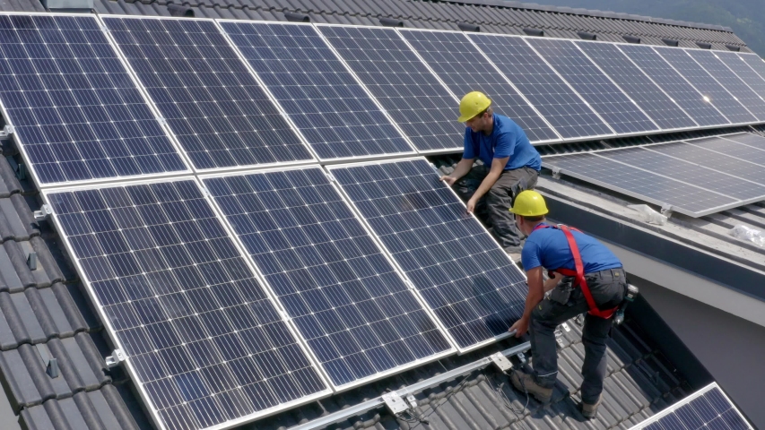 Working Making Sure Solar Panels Are Fitting Properly On Roof. Aerial Royalty-Free Stock Footage #1038878423