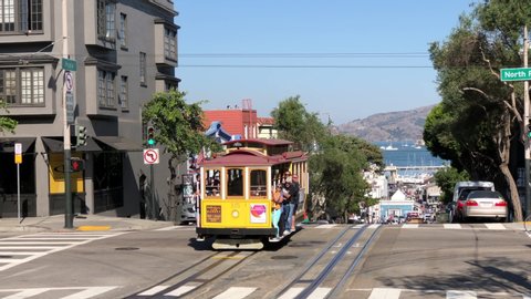 San Francisco, CA - Oct 11, 2019: 4K HD video of Trolly leaving Hyde St station heading up the hill. The San Francisco cable car system is the worlds last manually operated cable car system, an icon