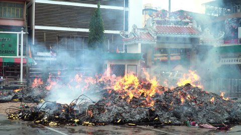 CHONBURI, THAILAND-OCTOBER 7, 2019:  Pople burning joss paper for deaded. In Happy new year festival, vegetarian festival. Mountain ashy of burning joss paper or ghost money in ceremony faith.