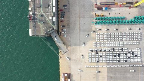 Aerial view of the huge ro-ro ship loading hunderds of cars. Automotive container carriers  oversea services.  Transportation business for prefabricated cars  by seafrieght.