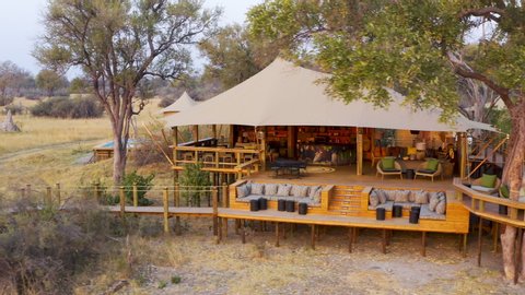 Close-up aerial panning view of the outside deck area and boma at Tuludi Safari Camp, Okavango Delta, Botswana