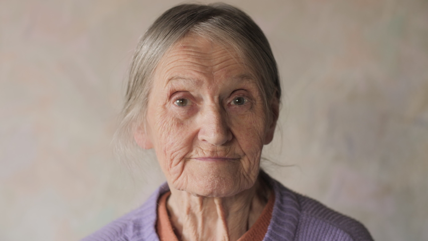Close up portrait of a happy elderly senior woman looking at camera and smiling.  4K UHD. | Shutterstock HD Video #1038911585