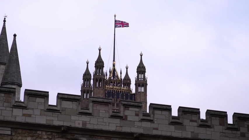 Union jack flag on Palace of Westminster, Houses of Parliament in London. Concept of UK urban life, financial business center, capital city.
