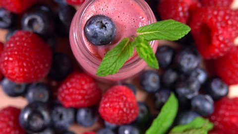 Variety of fresh fruit rotating, blended protein smoothie, healthy eating. Milk yogurt with mint leaves and raspberries. Refreshing mix of strawberries and blackberries, fitness, diet and detox