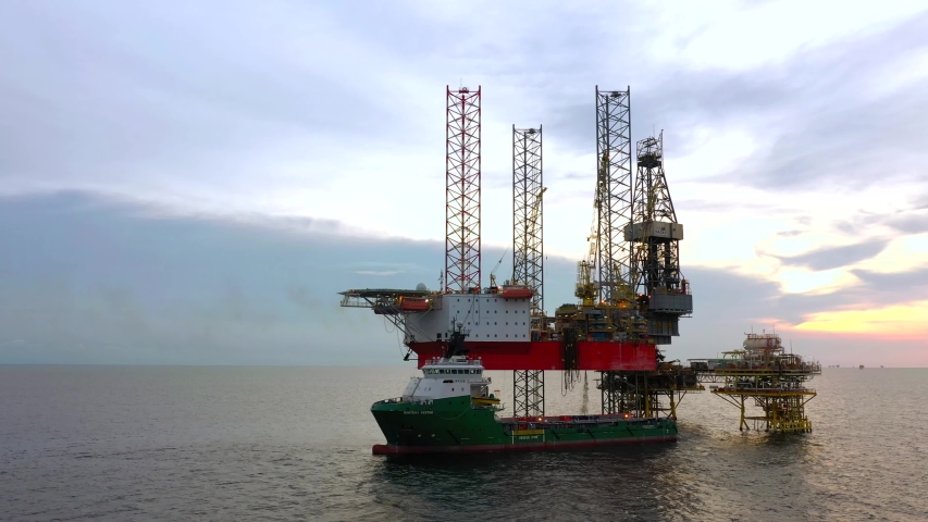 SARAWAK, MALAYSIA - OCTOBER 12, 2019: Standby vessel nearby Velesto Naga 7 offshore jack-up drilling rig in Malaysian Waters with beautiful sunset sky. | Shutterstock HD Video #1038929960