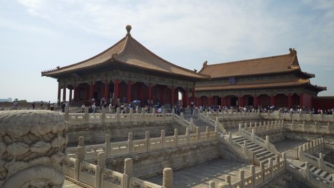 Crowd walking on footpath by historic building in Forbidden City against sky - Beijing, China