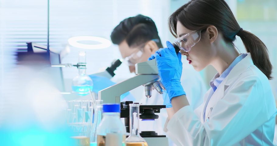 asian scientist team use microscope in the laboratory Royalty-Free Stock Footage #1038943358