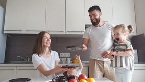 Father having fun with pancakes in the kitchen, man boasting about his cooking skills - Powered by Shutterstock - Get 15% off with code: PIKWIZARD15