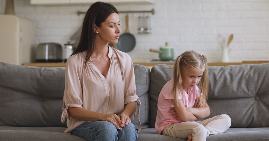 Angry young mother scolding shouting at stubborn fussy little kid daughter demand discipline lecturing disobedient difficult rebellious child ignoring not listening to annoyed mom sit on sofa at home Royalty-Free Stock Footage #1038952478