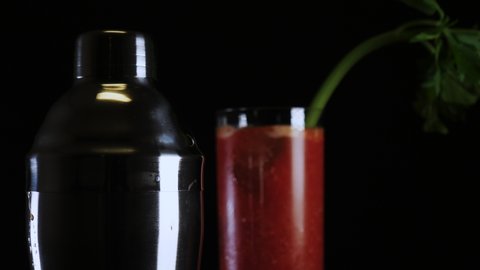 Freshly mixed Bloody Mary drink cocktail against black background