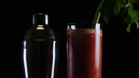 A fresh bloody mary drink cocktail isolated against black background