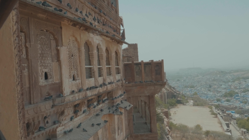 Panning Around Jodhpur Fort India Covered In Birds To A Lookout View Of The City At Sunrise