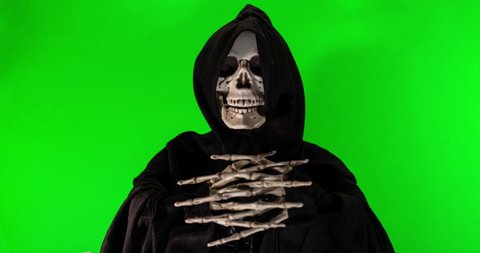 Talking skeleton with black scarf stop motion footage on a green background with alpha channel.