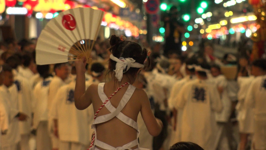 KYOTO, JAPAN - 17 JULY 2019 : Scenery of GION MATSURI (FESTIVAL) at night. Famous summer event in Japan. Back shot of unidentified young girl enjoying the festival. Royalty-Free Stock Footage #1038958958