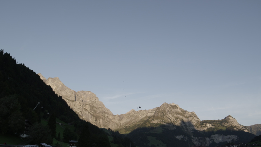 helicopter flying towards titlis mountain village