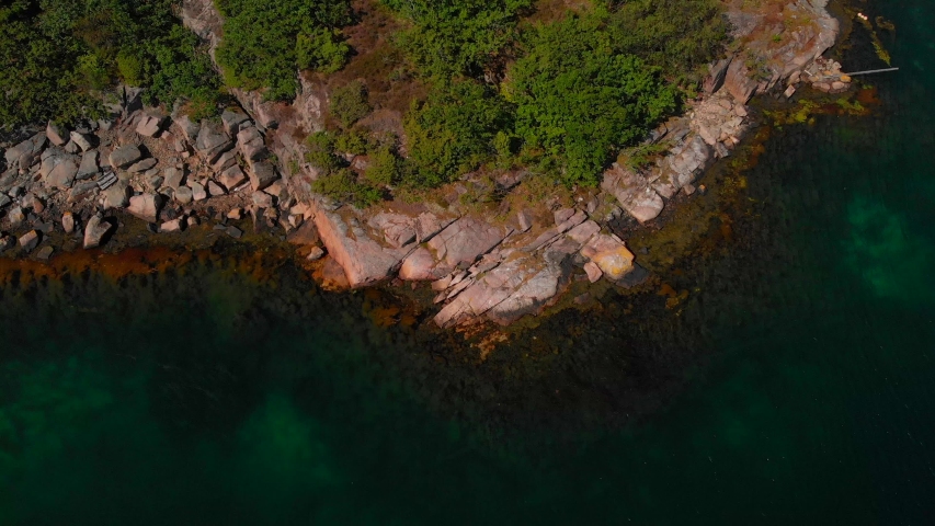 Overhead drone view of cliffs and sea at summer.