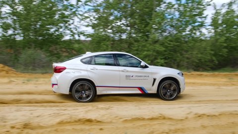 Moscow, Russia - May, 2019: Offroad extreme safari driving on BMW X6M F86. Fast acceleration in the sand