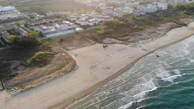 Aerial view of sandy beach, city and sea