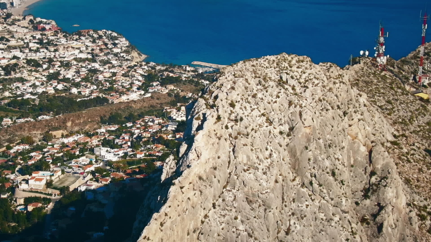 Aerial view of Gibraltar Limestone Rock and the city below. Clear ocean waters in the background. British Overseas Territory