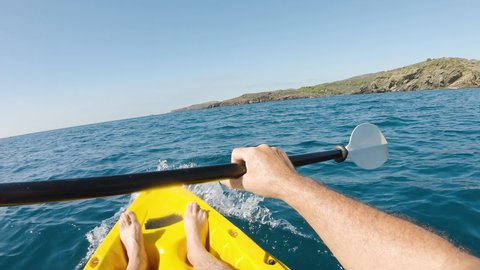 First person view kayaking with a kayak in the mediterranean sea on a sunny summer day. Concept about summer, lifestyle,wanderlust travel and nature