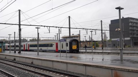 (Brugge) Bruges, Belgium - October 11 2019: The train arrives at the station. The train leaves the station.