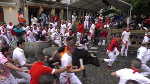 PAMPLONA, SPAIN - JULY 2016. The Running of the Bulls during San Fermin Festival in famous Estafeta St of Pamplona, July 2019
