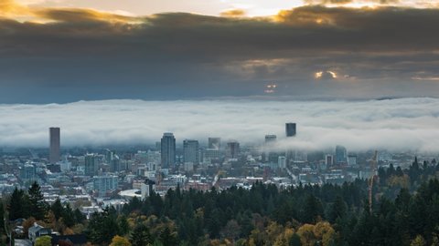 Portland downtown and autumn foliage with rolling fog and shiny rising sun in time lapse video