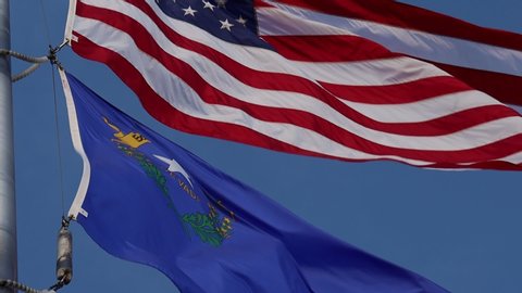 US and Nevada state flags flying low POV in slow motion 120 fps