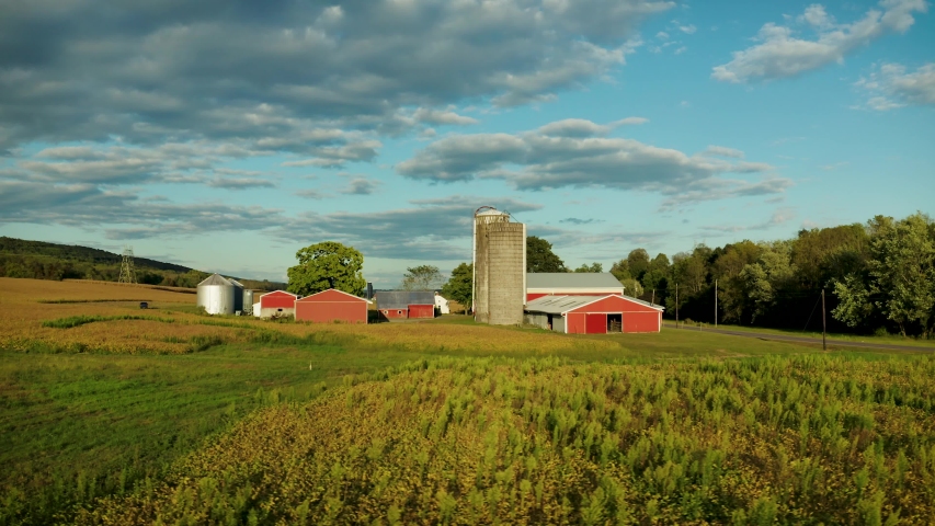 4K aerial footage of a farm on a beautiful sunny day
