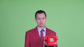 Face of angry Asian businessman using telephone and shouting - Powered by Shutterstock - Get 15% off with code: PIKWIZARD15