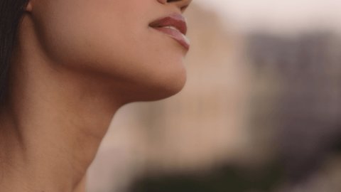 Close-up beauty portrait of young woman with smooth healthy skin enjoying the sunset