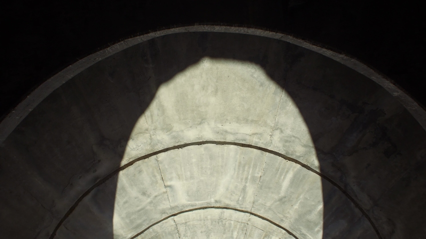 Two women watching inside of a circular cement building