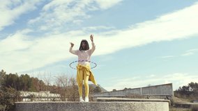 Woman dancing with a hula hoop - Powered by Shutterstock - Get 15% off with code: PIKWIZARD15