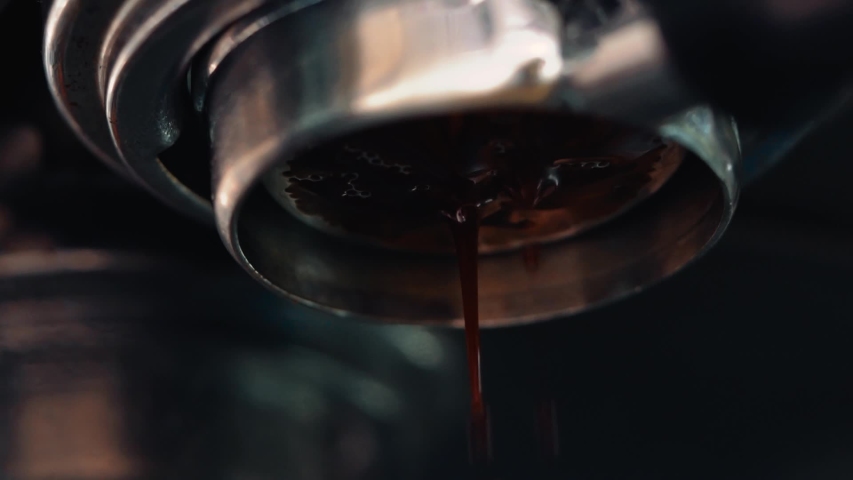 Flowing fresh ground coffee. Pouring coffee stream from professional machine in cup.  | Shutterstock HD Video #1039032590