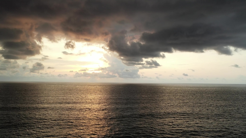 Breathtaking Aerial View of a Bird Flying Over Water in Front of a Colorful Sunset. Sayulita Beach. Nayarit, Mexico.
