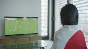 Proud Japanese girl supporter wrapped in Japanese flag cheering players in a rugby match. Shot on Red Camera. Slow motion. Patriot and sports fan concepts. - Powered by Shutterstock - Get 15% off with code: PIKWIZARD15