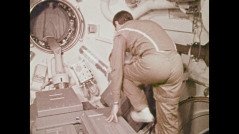 1970s: UNITED STATES: crewman sets up spectrometer and sequence camera inside Skylab.