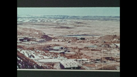 1970s: UNITED STATES: ground images reconstruction from camera images. Hand points out details on photos. Combines data from Skylab. View of coast from space.