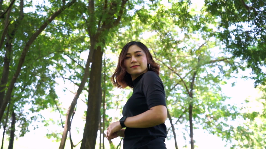 slow-motion of cheerful woman in the park